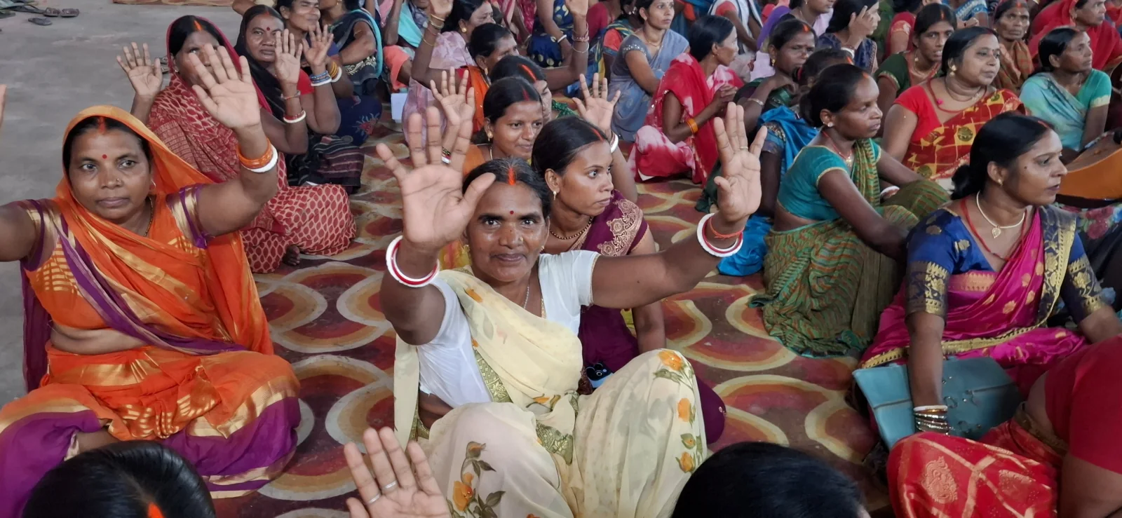 Women participating in a community decision-making meeting