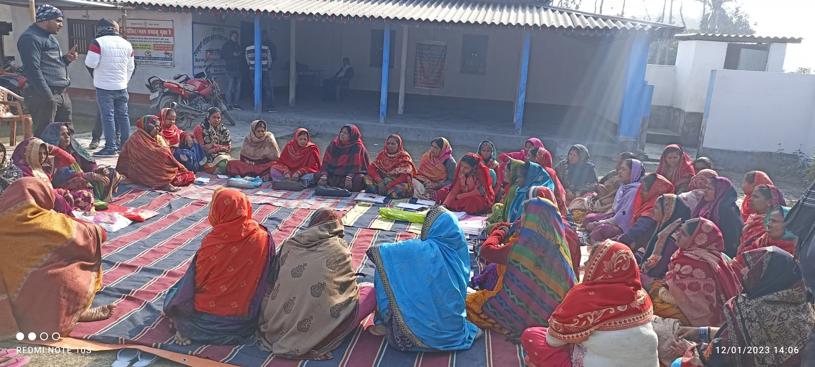Women attending a Jeevika self-help group meeting outdoors