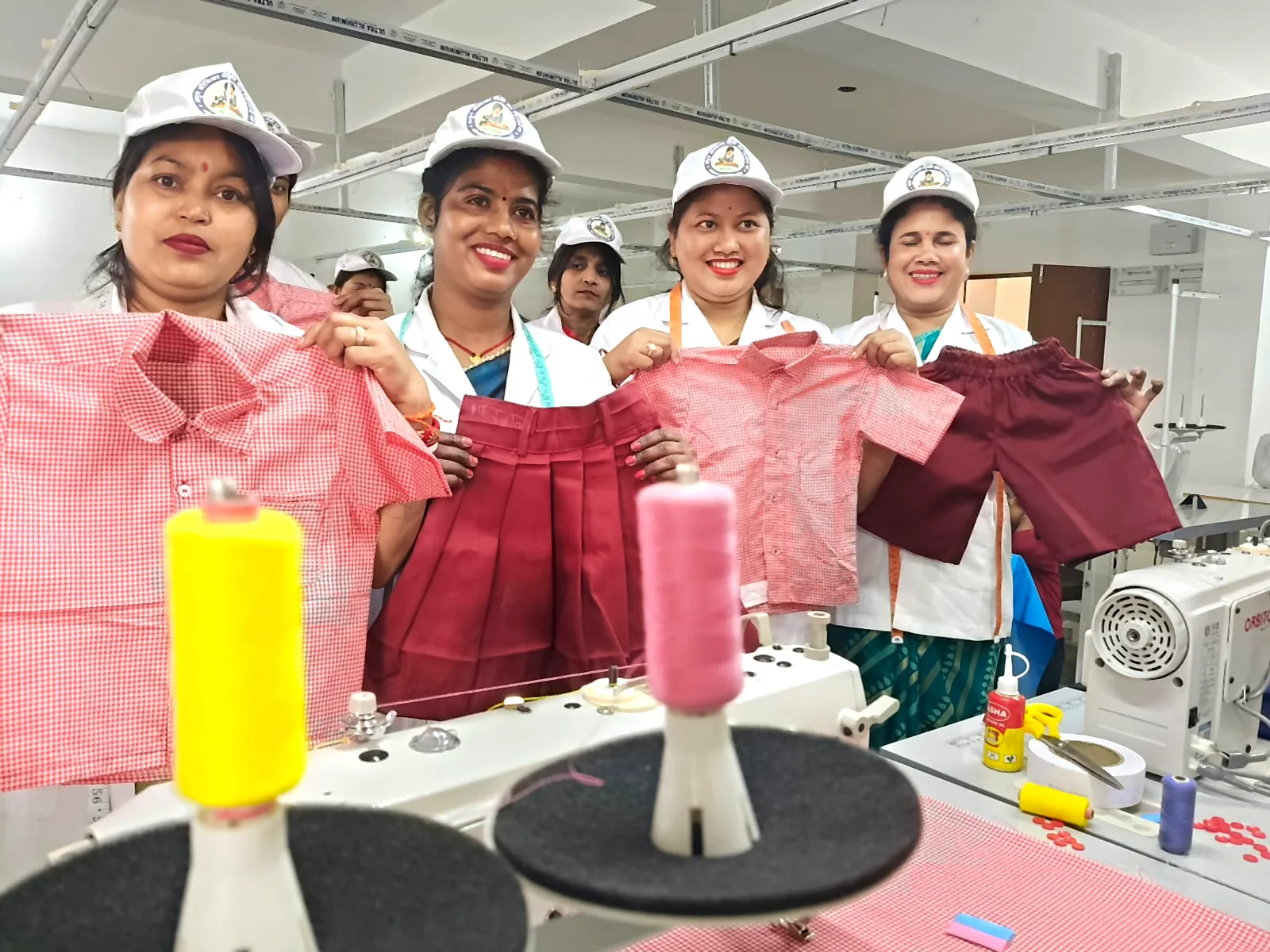 Jeevika women displaying garments produced through tailoring work