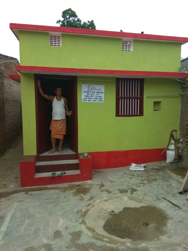 Completed PMAY-G house with beneficiary